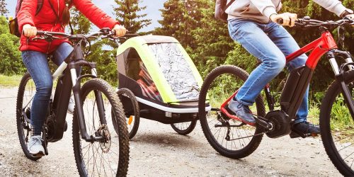 Family riding e-bikes in a residential neighborhood