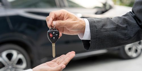 Driver borrowing a vehicle and holding car keys, representing non-owner auto insurance coverage