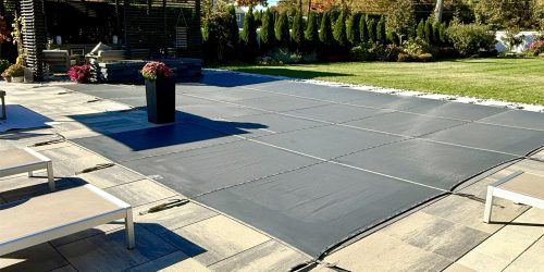 Residential swimming pool covered for winter as part of fall home maintenance