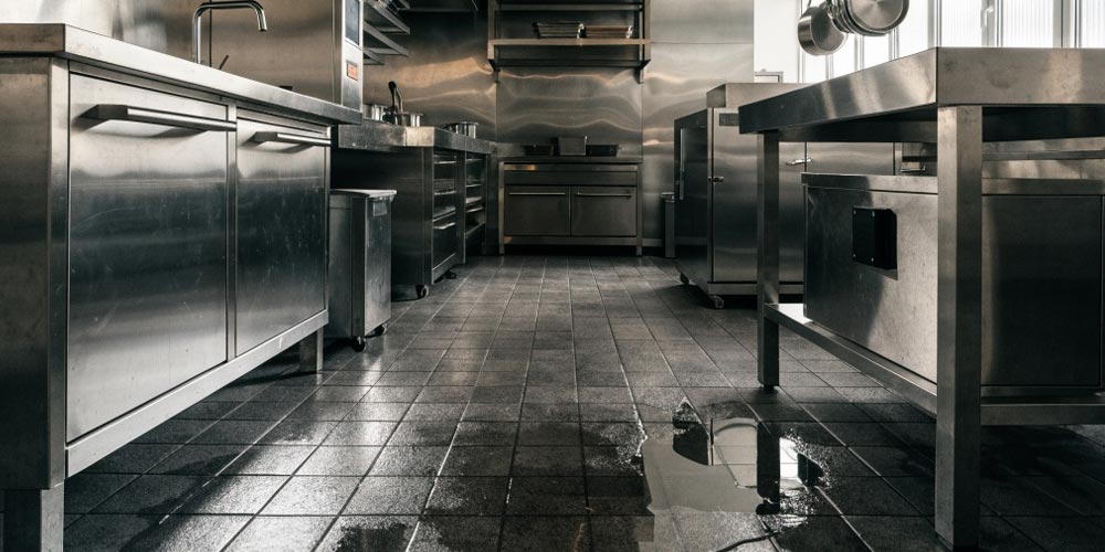 Water damage in a restaurant kitchen illustrating a common business insurance risk